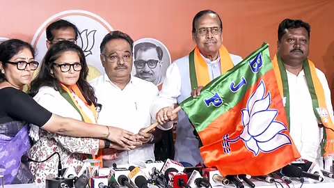Samik Bhattacharya with other party members holding a Bharatiya Janata Party flag at a joining ceremony before a bank of microphones